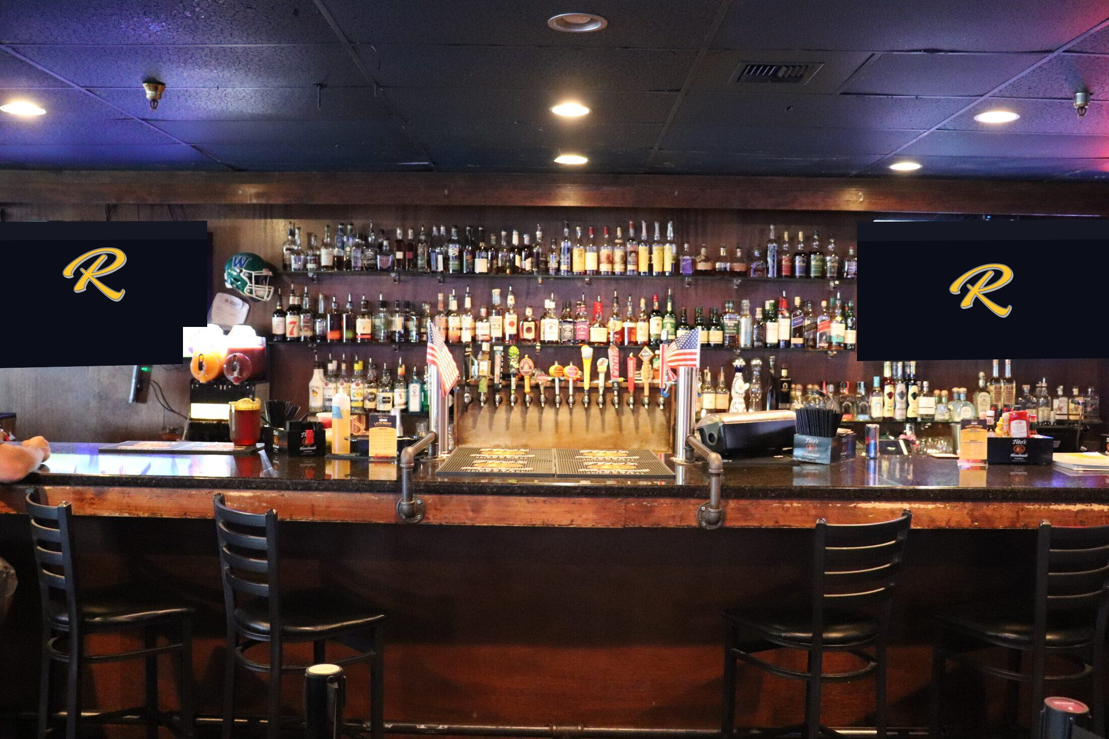 Rooneys back bar and whiskey wall under a row of TVs