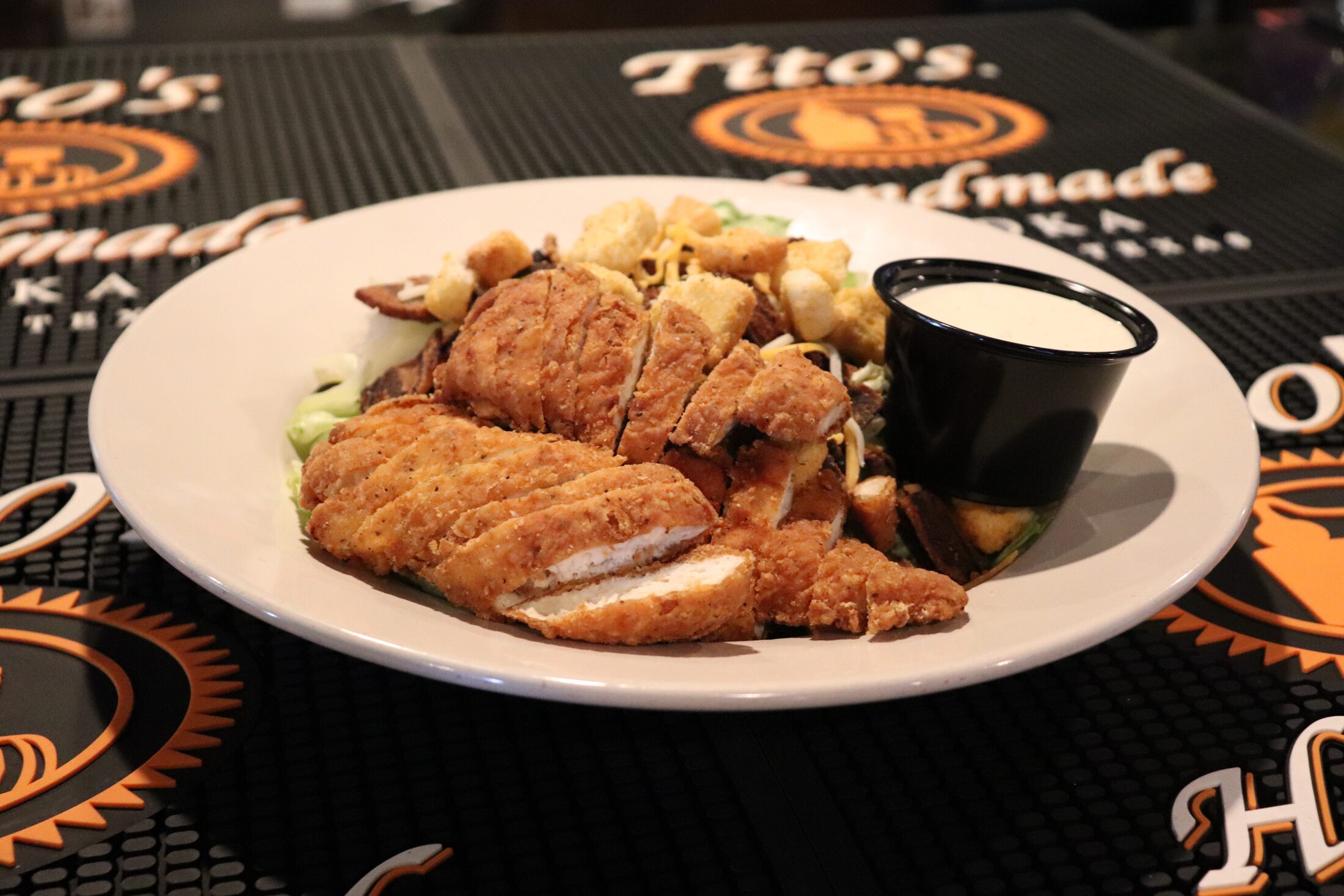 Fried chicken salad with crispy chicken over fresh greens at Rooneys in Woodinville