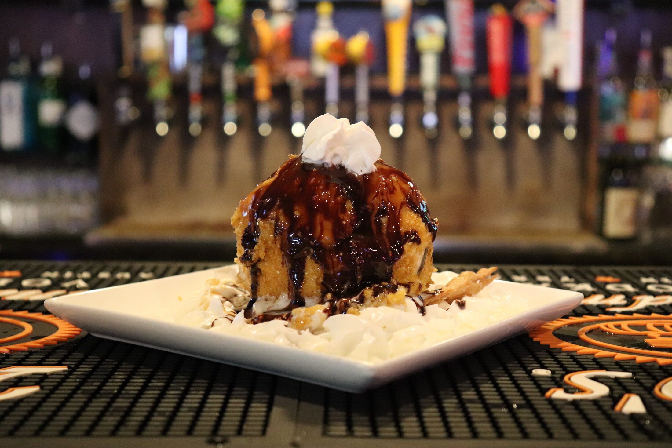 Fried ice cream with chocolate sauce on the bar in front of the taps at Rooneys in Woodinville