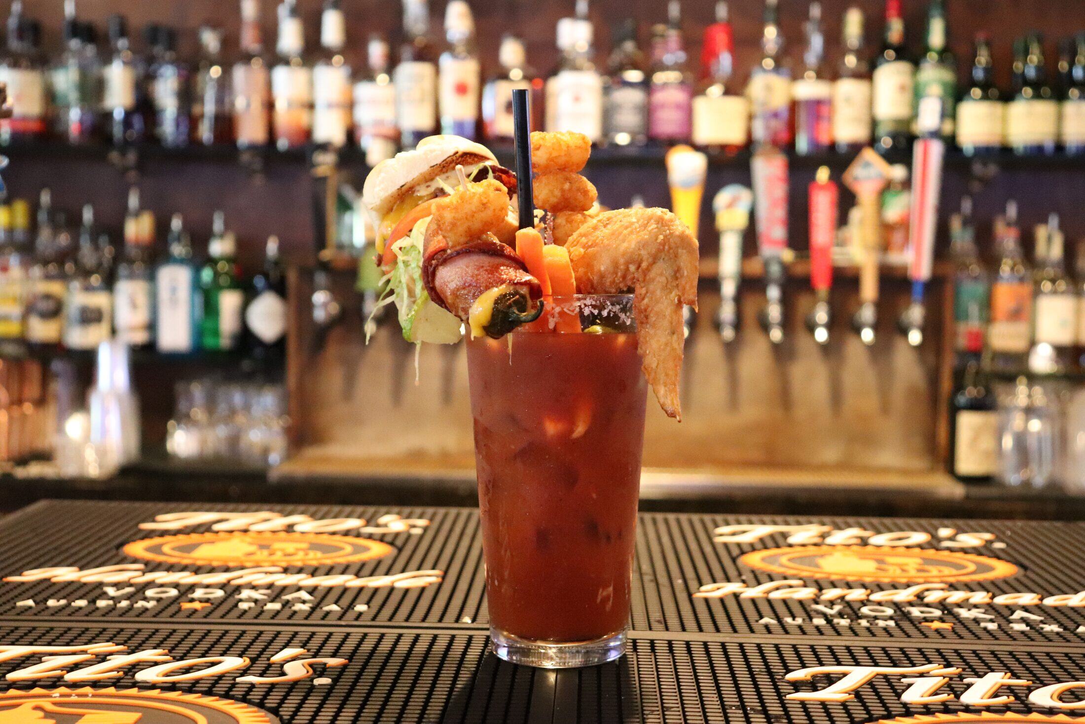 Loaded bloody mary topped with a wing and slider at Rooneys