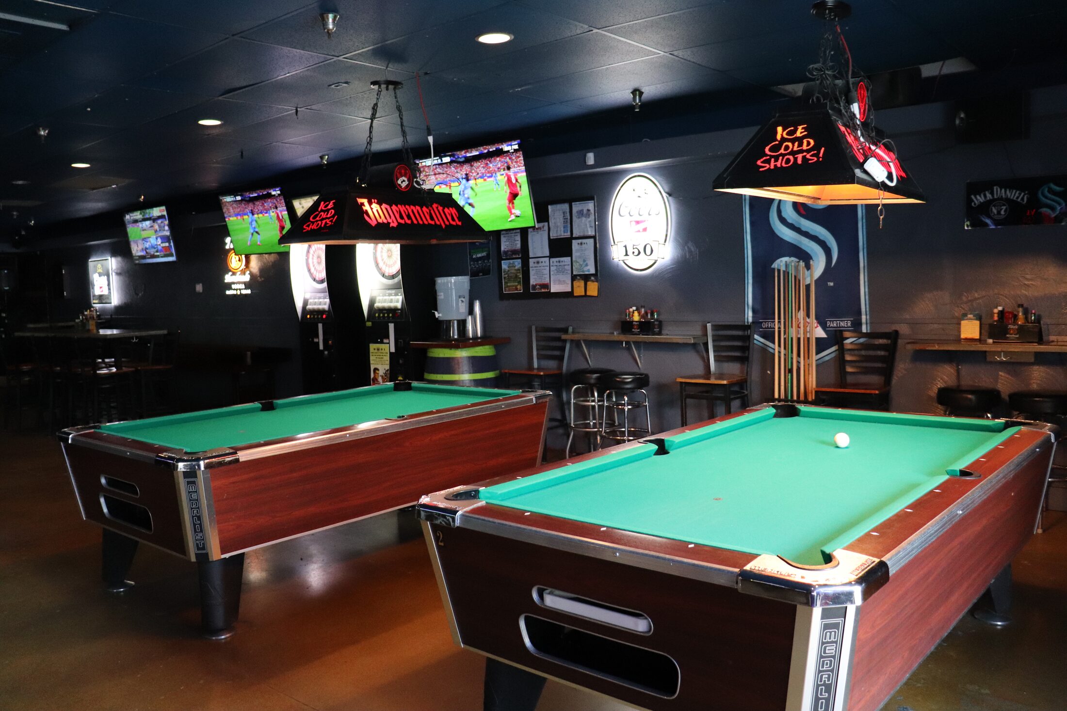 Pool tables, dartboards and cue racks in Rooneys game area