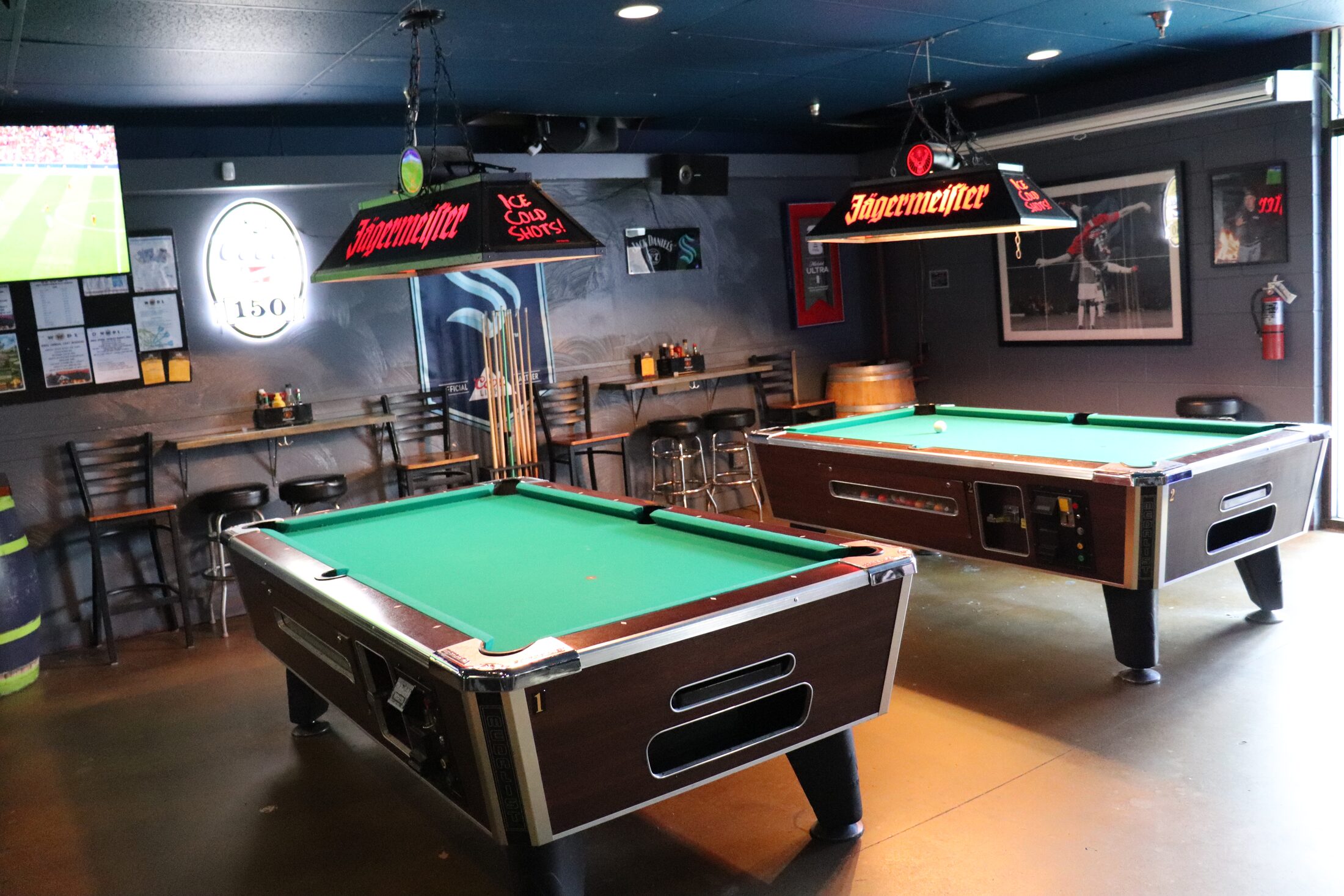 Pool tables under Jägermeister lights at Rooneys